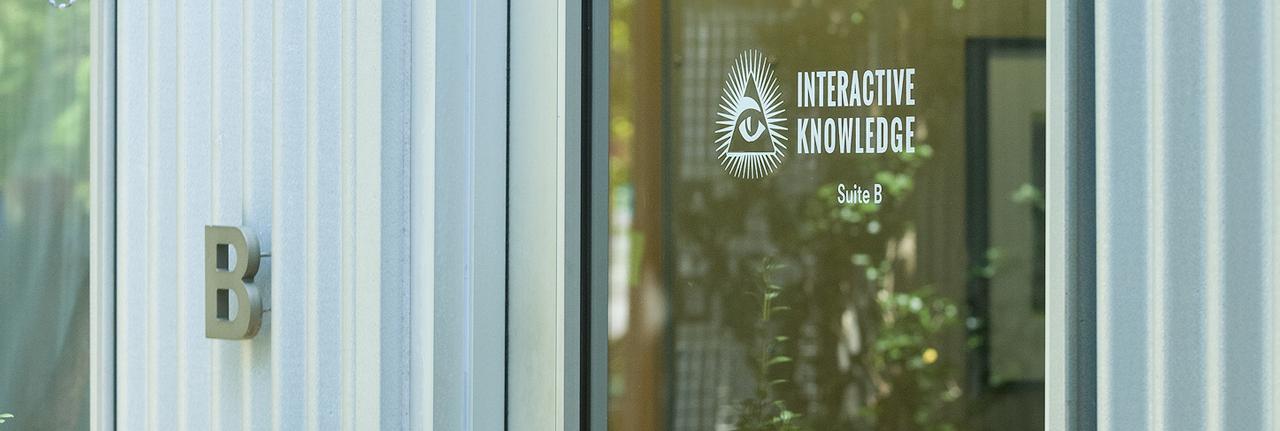 Interactive Knowledge logo on glass window.