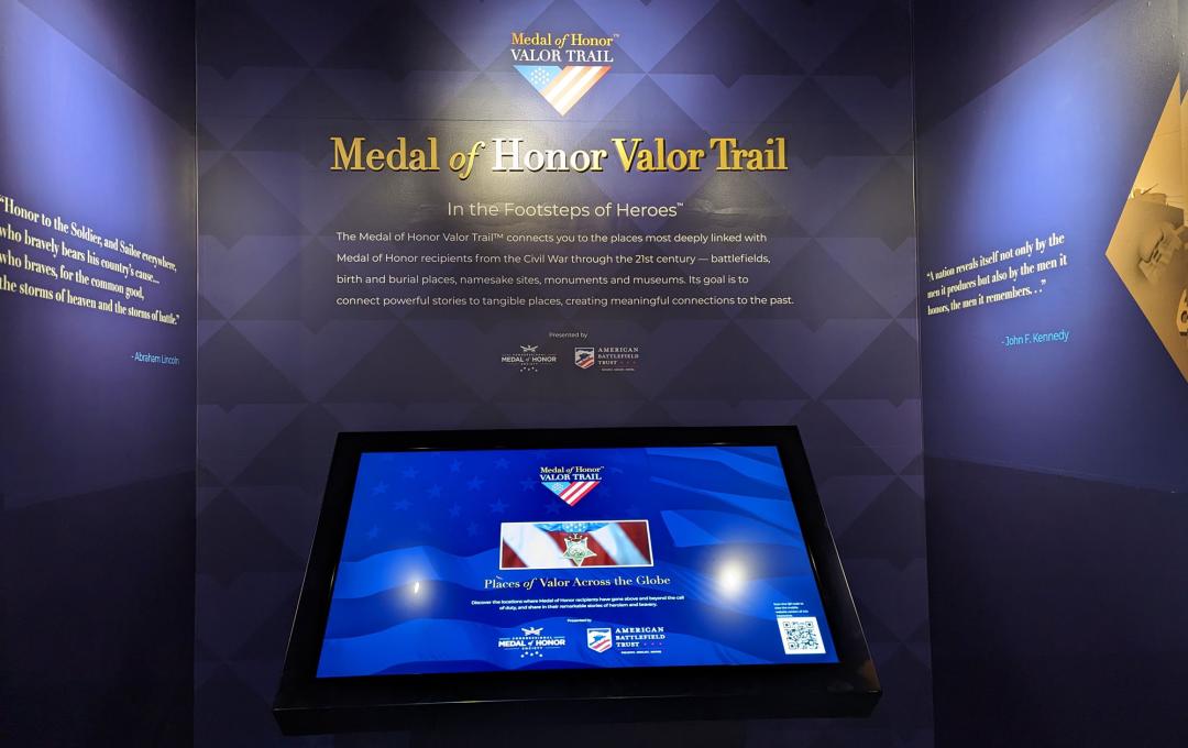 a kiosk located in a museum with deep blue walls and gold text that reads Medal of Honor Valor Trail